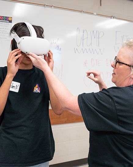 A teacher and students in a classroom funded by a grant